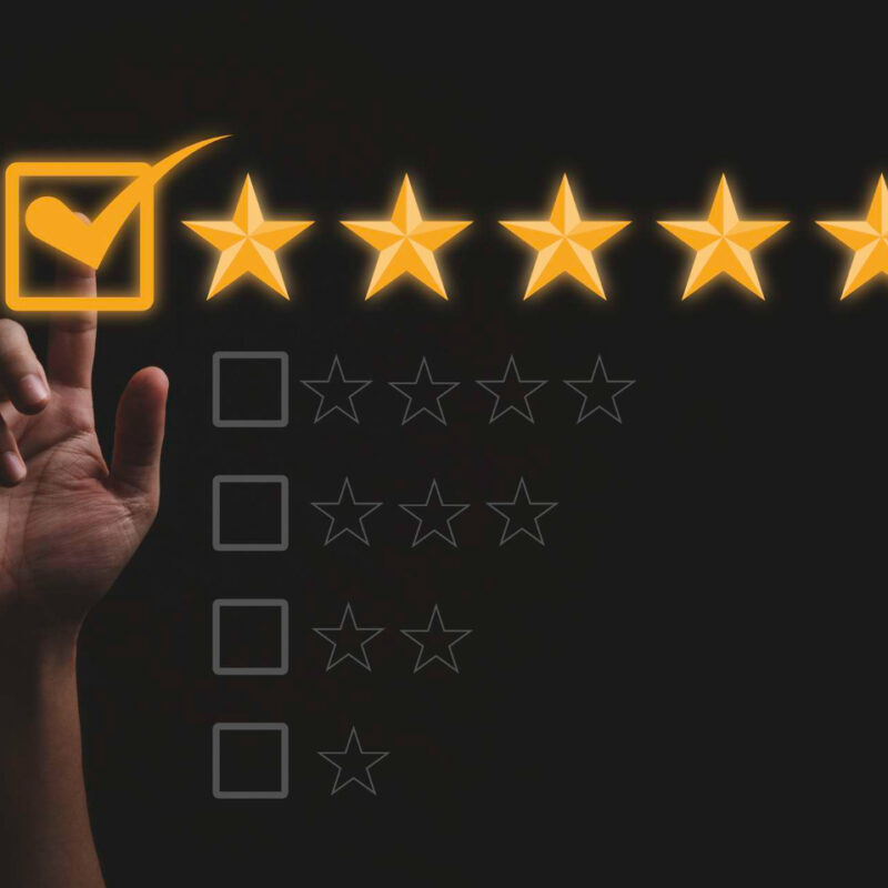 Hand touching and doing mark to five yellow stars on black background the best customer satisfaction and evaluation for good quality product and service